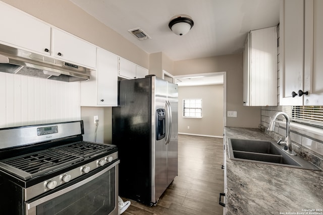 kitchen featuring dark wood-type flooring, appliances with stainless steel finishes, sink, and white cabinets