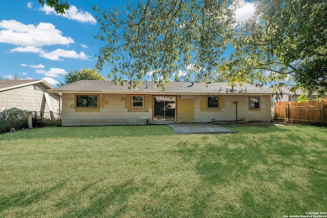 rear view of house with a yard and a patio area