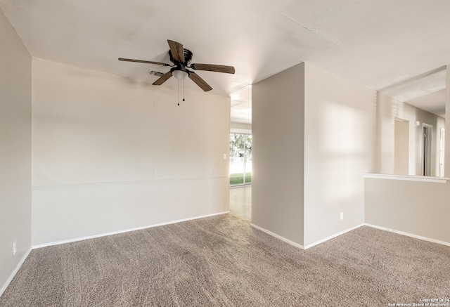 spare room featuring carpet and ceiling fan