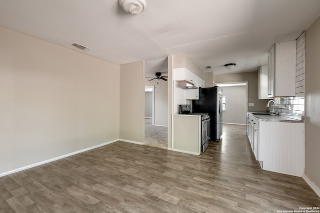 kitchen featuring wood-type flooring, sink, white cabinets, appliances with stainless steel finishes, and ceiling fan