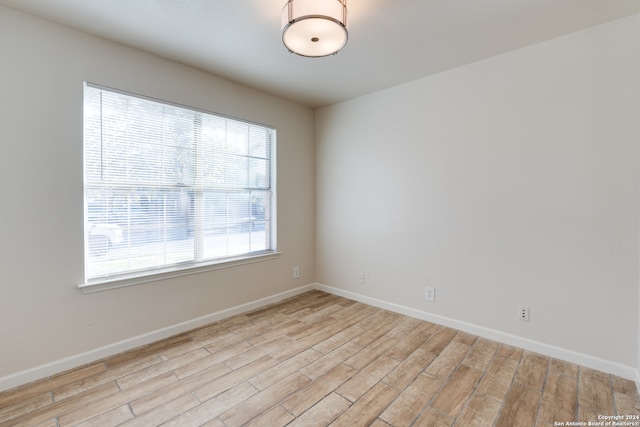 spare room with light hardwood / wood-style floors