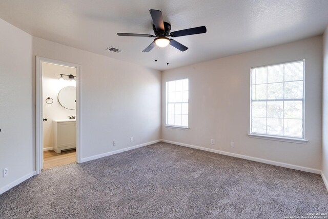 7419 Cedar Farm, San Antonio, TX 78239 - unfurnished bedroom featuring baseboards, visible vents, carpet, and ensuite bath