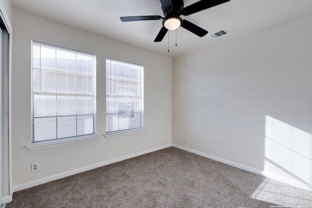 spare room featuring carpet floors and ceiling fan