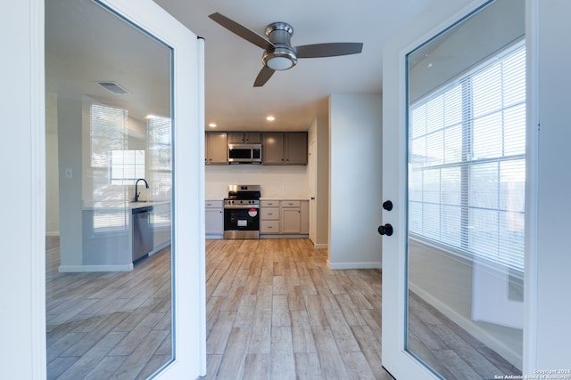 interior space featuring light hardwood / wood-style floors, sink, and ceiling fan