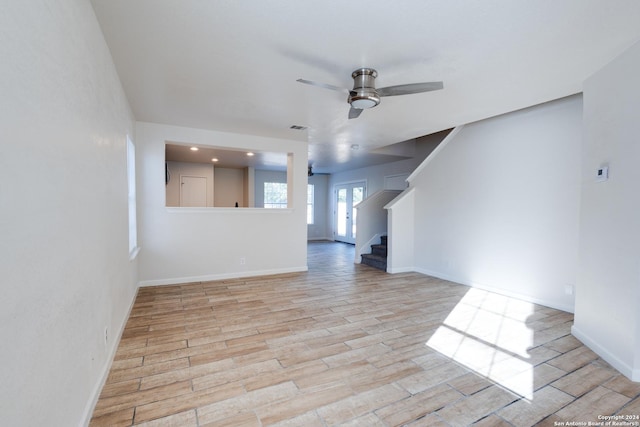 7419 Cedar Farm, San Antonio, TX 78239 - unfurnished living room featuring ceiling fan, stairs, baseboards, light wood-type flooring, and visible vents