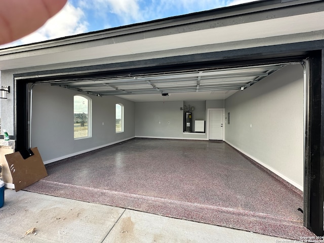 garage featuring a garage door opener and electric water heater