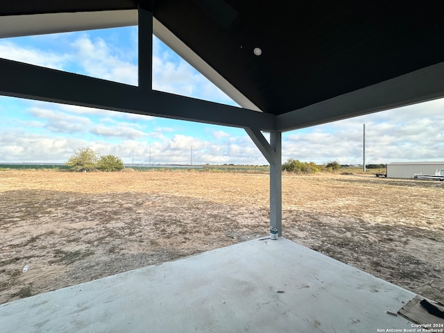 view of yard featuring a patio area and a rural view