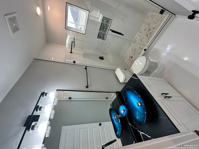 bathroom with toilet and walk in shower