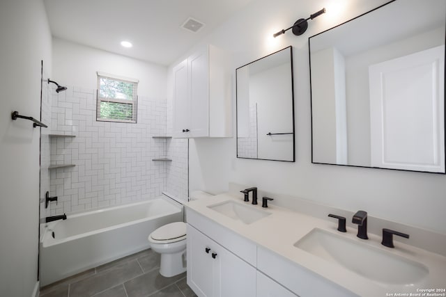 full bathroom with vanity, tiled shower / bath combo, toilet, and tile patterned floors