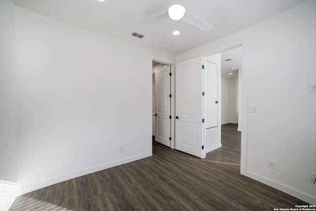 unfurnished bedroom with ceiling fan and dark hardwood / wood-style flooring