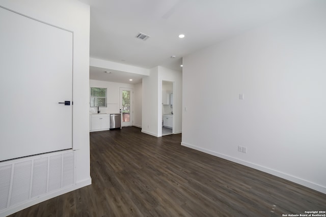 spare room featuring sink and dark wood-type flooring