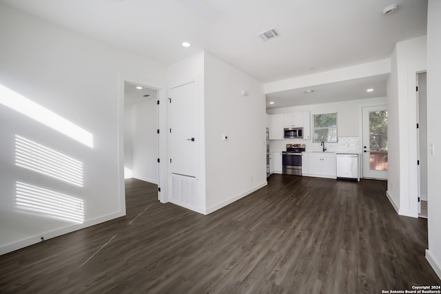 unfurnished living room with dark hardwood / wood-style floors and sink