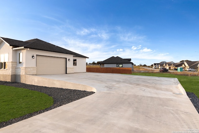 view of property exterior featuring a yard and a garage