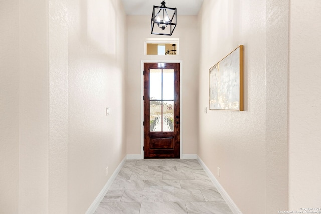 doorway with a notable chandelier