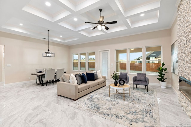 living room featuring crown molding, beam ceiling, coffered ceiling, and ceiling fan with notable chandelier