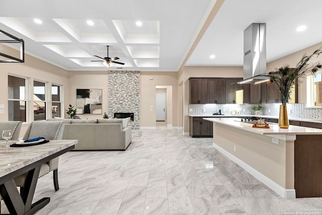 kitchen featuring beamed ceiling, coffered ceiling, dark brown cabinets, and backsplash