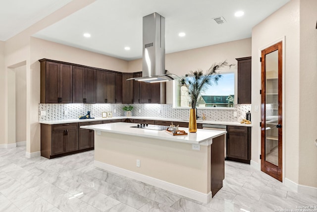 kitchen featuring island exhaust hood, tasteful backsplash, and a kitchen island