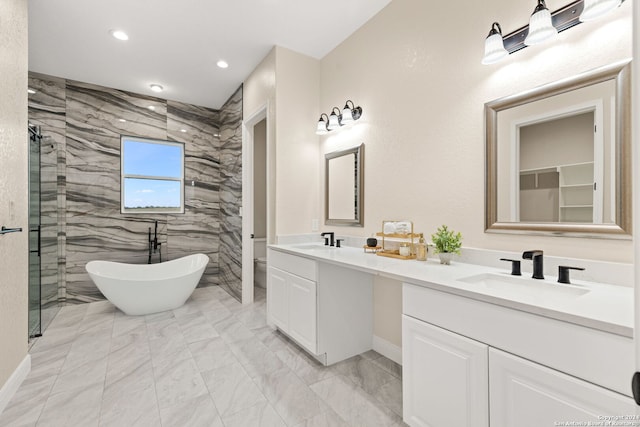 bathroom with vanity and shower with separate bathtub