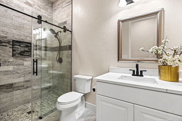 bathroom featuring vanity, toilet, and an enclosed shower