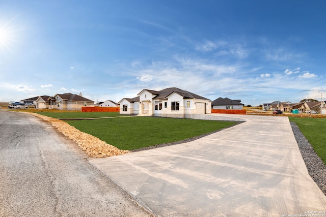 ranch-style house featuring a front yard and a garage