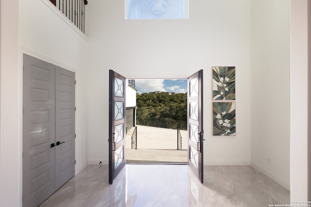 foyer with french doors and a high ceiling