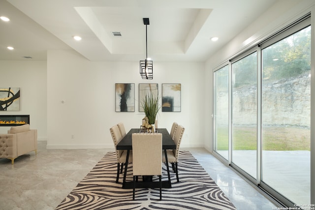 dining space featuring a tray ceiling