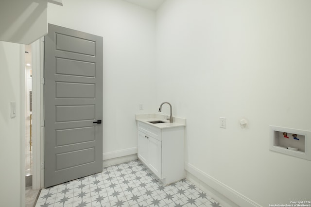 washroom featuring cabinets, sink, and washer hookup