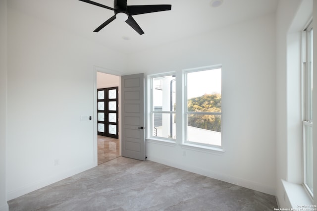 spare room featuring ceiling fan and french doors