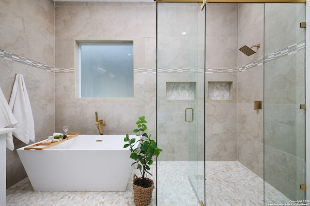 bathroom with separate shower and tub