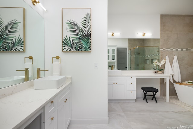 bathroom featuring vanity and independent shower and bath