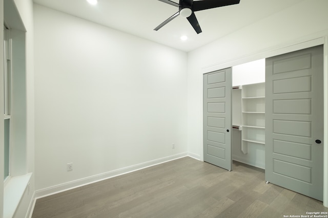 unfurnished bedroom with ceiling fan, a closet, and light hardwood / wood-style floors