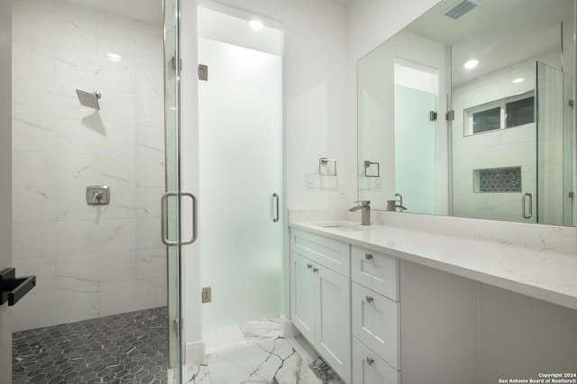 bathroom featuring vanity and a shower with door