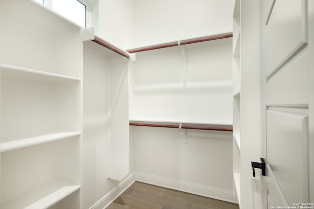 spacious closet with dark hardwood / wood-style floors