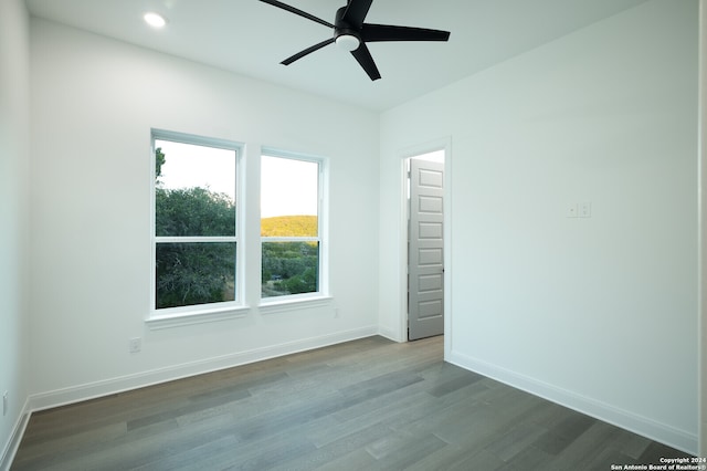 empty room with hardwood / wood-style flooring and ceiling fan