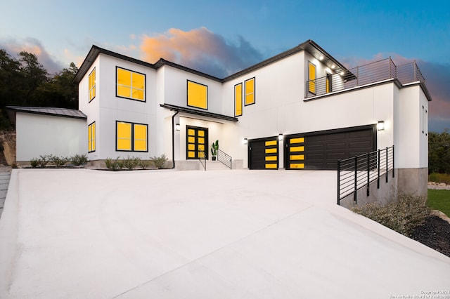 view of front facade featuring a balcony and a garage