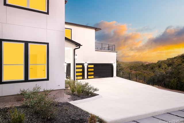 property exterior at dusk with a garage