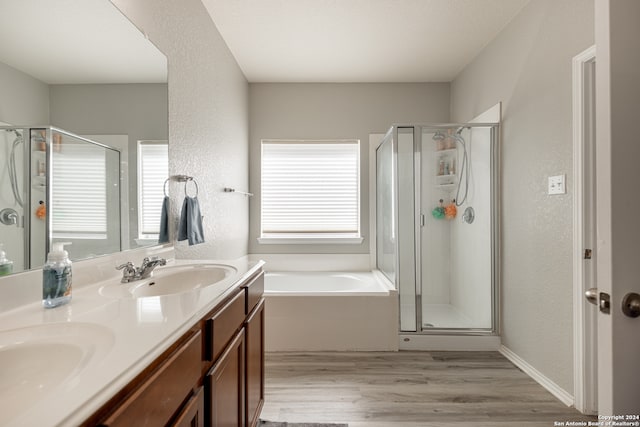 bathroom with vanity, hardwood / wood-style flooring, independent shower and bath, and plenty of natural light