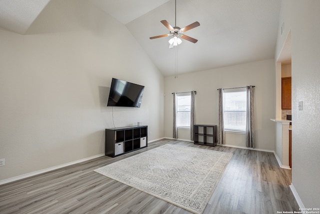 unfurnished living room featuring hardwood / wood-style flooring, high vaulted ceiling, and ceiling fan