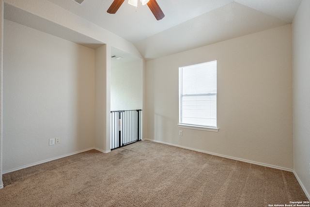 carpeted empty room with ceiling fan and vaulted ceiling