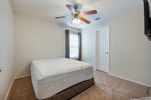 bedroom featuring ceiling fan and light carpet