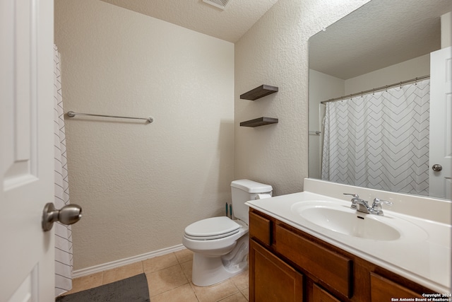 bathroom featuring toilet, a textured ceiling, vanity, and tile patterned flooring