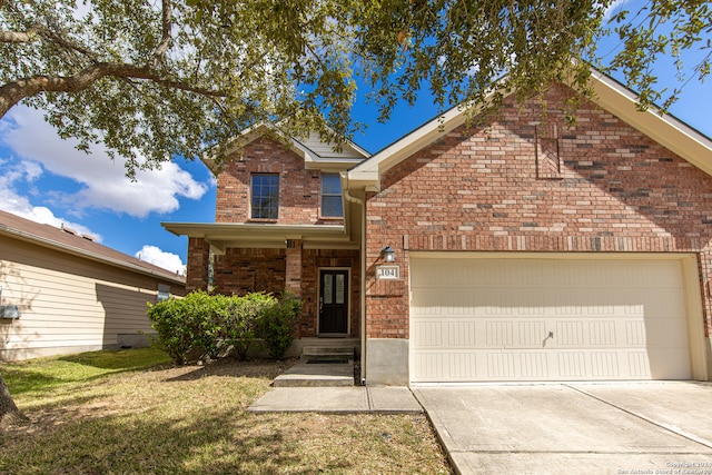 front facade featuring a front lawn and a garage