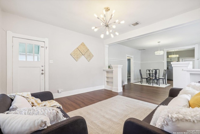 1112 W Huisache Ave, San Antonio, TX 78201 - living room featuring baseboards, a notable chandelier, wood finished floors, and visible vents