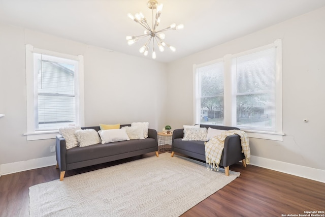 living room with a notable chandelier, dark hardwood / wood-style floors, and plenty of natural light