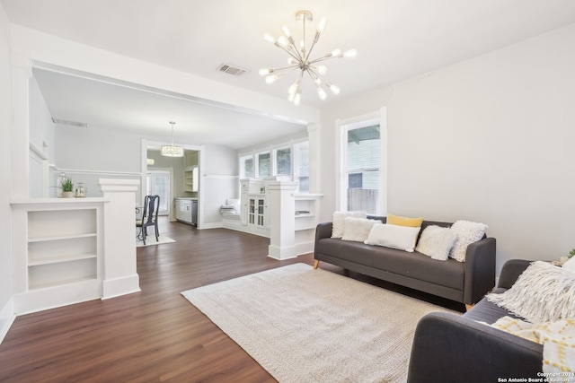 living room featuring an inviting chandelier and dark hardwood / wood-style floors