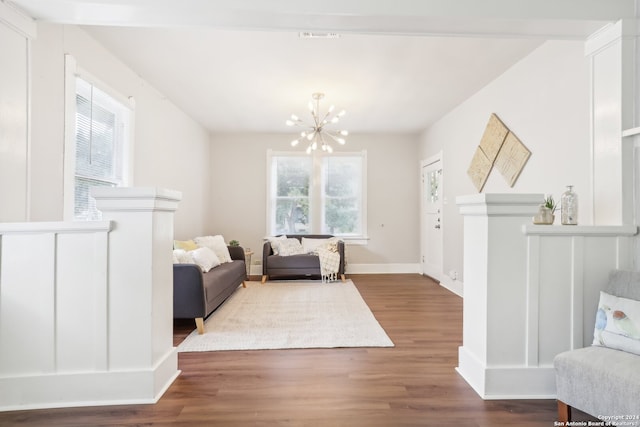 sitting room featuring dark hardwood / wood-style floors and a chandelier