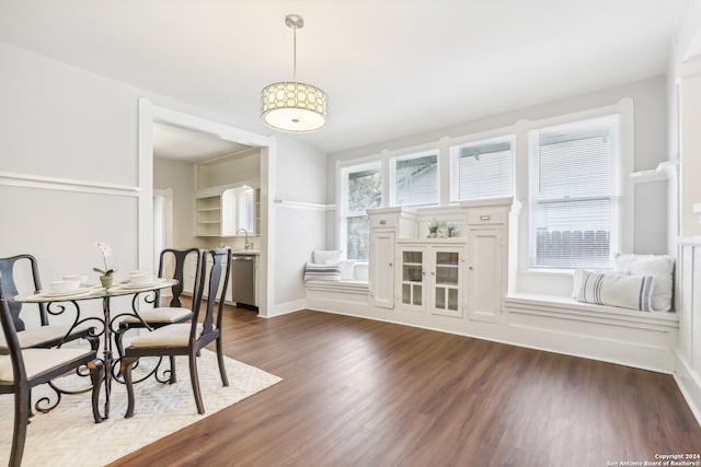 dining space with dark hardwood / wood-style floors and sink