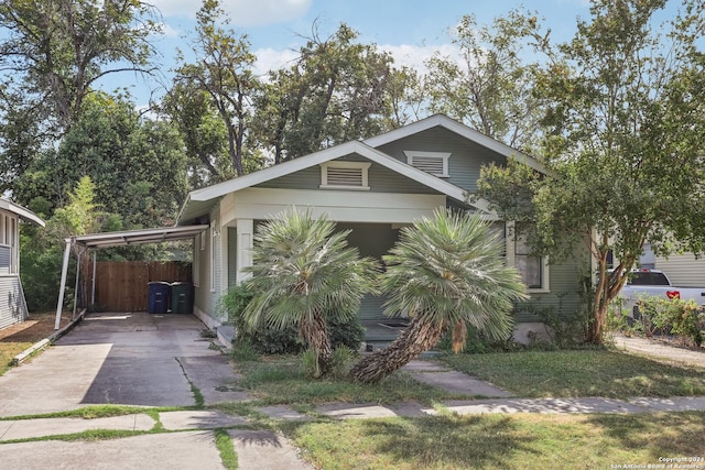 view of front of home with a front lawn and a carport