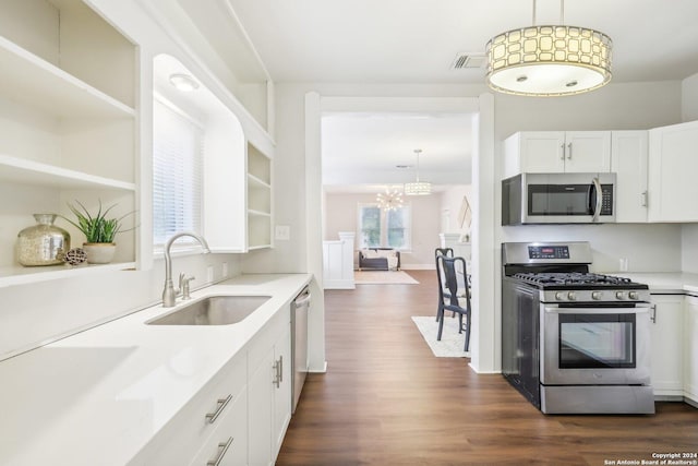 1112 W Huisache Ave, San Antonio, TX 78201 - kitchen featuring light countertops, a sink, dark wood finished floors, appliances with stainless steel finishes, and a notable chandelier