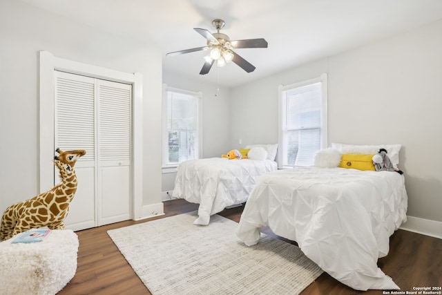 bedroom featuring a closet, dark hardwood / wood-style floors, and ceiling fan